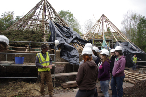 John explains all about the Thatching process with the massivce roundhouses in the background